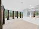 Bright living room with wall-to-wall windows and tile flooring at 703 W Sligh Ave, Tampa, FL 33604