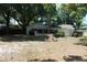 View of the home's exterior and large backyard from the rear at 7116 Kingsbury Cir, Tampa, FL 33610