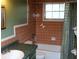 Bathroom with brown tile, green vanity, and a tub/shower combo at 7116 Kingsbury Cir, Tampa, FL 33610