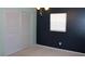 Bedroom with two-toned dark blue and light green walls and carpeted flooring at 7116 Kingsbury Cir, Tampa, FL 33610