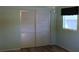 Bedroom with sliding closet doors, wood-look flooring, and light green walls at 7116 Kingsbury Cir, Tampa, FL 33610
