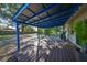 Covered back patio with wood decking and string lights at 7471 35Th N St, Pinellas Park, FL 33781