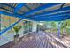Covered back patio with wood decking and string lights at 7471 35Th N St, Pinellas Park, FL 33781