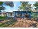 Large backyard with mature trees and a wooden deck at 7471 35Th N St, Pinellas Park, FL 33781
