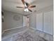 Spacious bedroom with wood-look floors, ceiling fan, and large closet at 7471 35Th N St, Pinellas Park, FL 33781