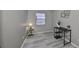 Cozy bedroom with gray walls, wood-look floors, and a small desk at 7471 35Th N St, Pinellas Park, FL 33781
