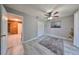 Bedroom with wood-look floors, ceiling fan, and access to hallway at 7471 35Th N St, Pinellas Park, FL 33781