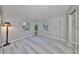 Bright bedroom featuring gray walls and wood-look floors at 7471 35Th N St, Pinellas Park, FL 33781