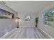 Spacious bedroom with gray walls, wood-look floors, and large windows at 7471 35Th N St, Pinellas Park, FL 33781