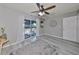 Bedroom with wood-look floors, ceiling fan, and sliding glass door to patio at 7471 35Th N St, Pinellas Park, FL 33781