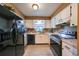 Modern kitchen with black appliances, white cabinets, and butcher block countertops at 7471 35Th N St, Pinellas Park, FL 33781
