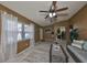 Spacious living area with tiled floors, a ceiling fan and a mirror reflecting the room at 7471 35Th N St, Pinellas Park, FL 33781