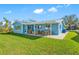 Newly renovated home with a spacious backyard, covered patio, and sitting area at 819 59Th Ave, St Pete Beach, FL 33706