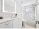 White bathroom with hexagon tile shower, bathtub and quartz countertop at 819 59Th Ave, St Pete Beach, FL 33706