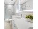 Bright bathroom with white vanity, large mirror, and walk-in shower at 819 59Th Ave, St Pete Beach, FL 33706