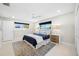 King-size bed, large windows, and ensuite bathroom at 819 59Th Ave, St Pete Beach, FL 33706