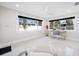 An airy room with bright windows and a desk presents the perfect work from home office at 819 59Th Ave, St Pete Beach, FL 33706
