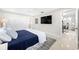 A modern bedroom with white ceiling fan, large television, and walk-in closet at 819 59Th Ave, St Pete Beach, FL 33706