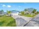 House exterior featuring a white garage door and landscaping at 819 59Th Ave, St Pete Beach, FL 33706