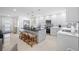A modern kitchen with an island, breakfast bar seating, and stainless steel appliances for cooking at 819 59Th Ave, St Pete Beach, FL 33706