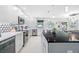 Modern kitchen with white cabinets, a large island, and terrazzo floors at 819 59Th Ave, St Pete Beach, FL 33706
