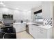 White kitchen with stainless steel appliances and a geometric backsplash at 819 59Th Ave, St Pete Beach, FL 33706