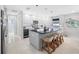 Updated kitchen with white cabinets, a large island, and terrazzo floors at 819 59Th Ave, St Pete Beach, FL 33706
