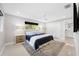 Serene main bedroom with neutral tones, a large window, and an ensuite bathroom for convenience at 819 59Th Ave, St Pete Beach, FL 33706