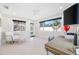 Bright home office with large windows and a ceiling fan at 819 59Th Ave, St Pete Beach, FL 33706