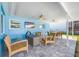 Relaxing patio area with seating, fire pit, and ceiling fans at 819 59Th Ave, St Pete Beach, FL 33706