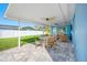 Covered patio with ceiling fans and comfortable outdoor seating at 819 59Th Ave, St Pete Beach, FL 33706