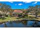 Aerial view showcasing the backyard, screened lanai, lake and landscaping at 1160 Darlington Oak Ne Dr, St Petersburg, FL 33703