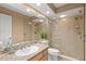Well-lit bathroom featuring a granite countertop and a glass-enclosed shower with tiled walls at 1160 Darlington Oak Ne Dr, St Petersburg, FL 33703