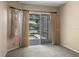 Cozy bedroom with carpet and sliding glass door to a screened lanai with pool and lake views at 1160 Darlington Oak Ne Dr, St Petersburg, FL 33703
