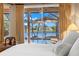 Bedroom view to the lanai, pool and lake featuring an umbrella shaded outdoor seating area at 1160 Darlington Oak Ne Dr, St Petersburg, FL 33703