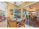 Cozy breakfast nook with views of the pool and lake, perfect for enjoying morning meals at 1160 Darlington Oak Ne Dr, St Petersburg, FL 33703