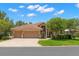 Beautifully landscaped home with a three-car garage and a red tile roof at 1160 Darlington Oak Ne Dr, St Petersburg, FL 33703
