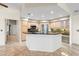Bright kitchen featuring a center island with a black countertop and light wood cabinets at 1160 Darlington Oak Ne Dr, St Petersburg, FL 33703