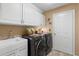 Convenient laundry room with washer, dryer, and cabinets at 1160 Darlington Oak Ne Dr, St Petersburg, FL 33703