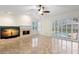 Open-concept living room with a fireplace, tiled floors, and sliding doors to the pool area at 1160 Darlington Oak Ne Dr, St Petersburg, FL 33703