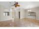 Spacious living room featuring tile floors, modern lighting, and views of the entryway at 1160 Darlington Oak Ne Dr, St Petersburg, FL 33703
