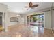 Open living room with tile flooring, a ceiling fan, and a sliding door to the screened-in lanai at 1160 Darlington Oak Ne Dr, St Petersburg, FL 33703
