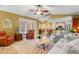 Spacious living room with tile flooring, a fireplace, and open access to the kitchen and dining areas at 1160 Darlington Oak Ne Dr, St Petersburg, FL 33703