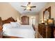 The main bedroom features a ceiling fan, traditional furniture and carpet at 1160 Darlington Oak Ne Dr, St Petersburg, FL 33703
