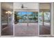 Patio view through sliding glass doors reveals pool and lake at 1160 Darlington Oak Ne Dr, St Petersburg, FL 33703