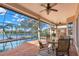 Inviting screened patio with outdoor seating, offering stunning views of the pool and lake at 1160 Darlington Oak Ne Dr, St Petersburg, FL 33703