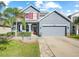 Two-story house with gray siding and red accents at 11938 Greenchop Pl, Riverview, FL 33579