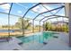 Inviting screened pool and lanai with lake view at 11938 Greenchop Pl, Riverview, FL 33579