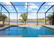 Enclosed pool and lanai overlooking lake at 11938 Greenchop Pl, Riverview, FL 33579