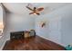 Bedroom with hardwood floors, ceiling fan, and simple decor at 150 Brent Cir, Oldsmar, FL 34677